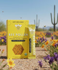 Happy Bees Market Arizona-sourced bee pollen single-serve packets displayed in an Arizona desert wildflower landscape.